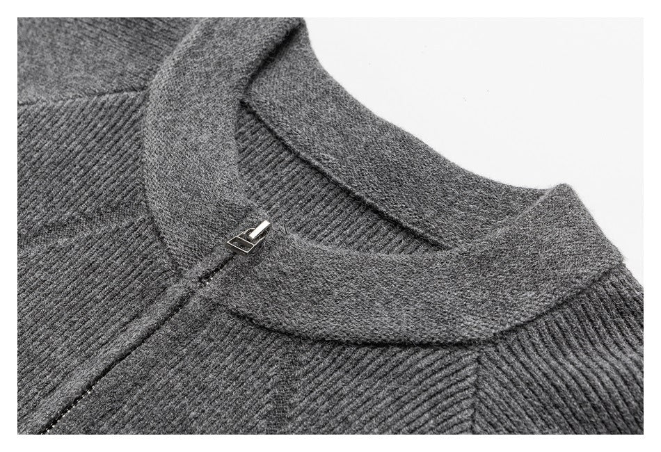 Close-up of a gray rib-knit cardigan collar and small metal zipper pull.