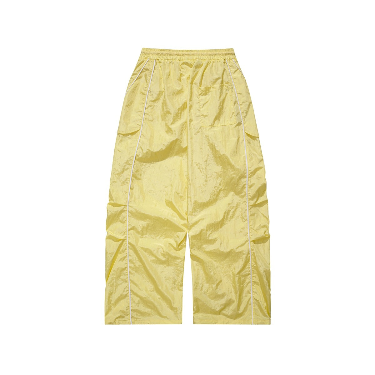 Front view of pale yellow wide-leg pants with an elastic waist, side flap pockets and white piping.