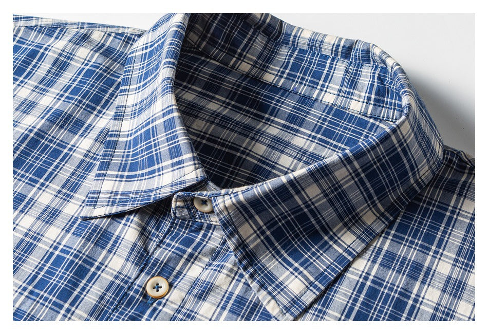 Close-up of the blue and white plaid shirt collar and front buttons.