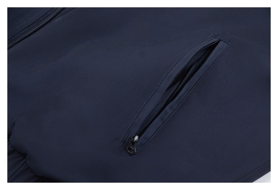 Close-up of a slanted zip pocket on dark navy fabric.