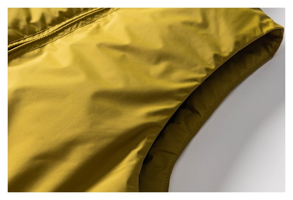 Close-up of mustard-yellow garment fabric with a curved stitched edge.