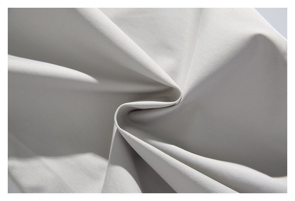 Light gray fabric twisted into folds, showing its smooth surface and drape.