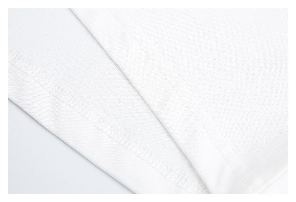 Close-up of white garment construction with overlock stitching and a folded seam.
