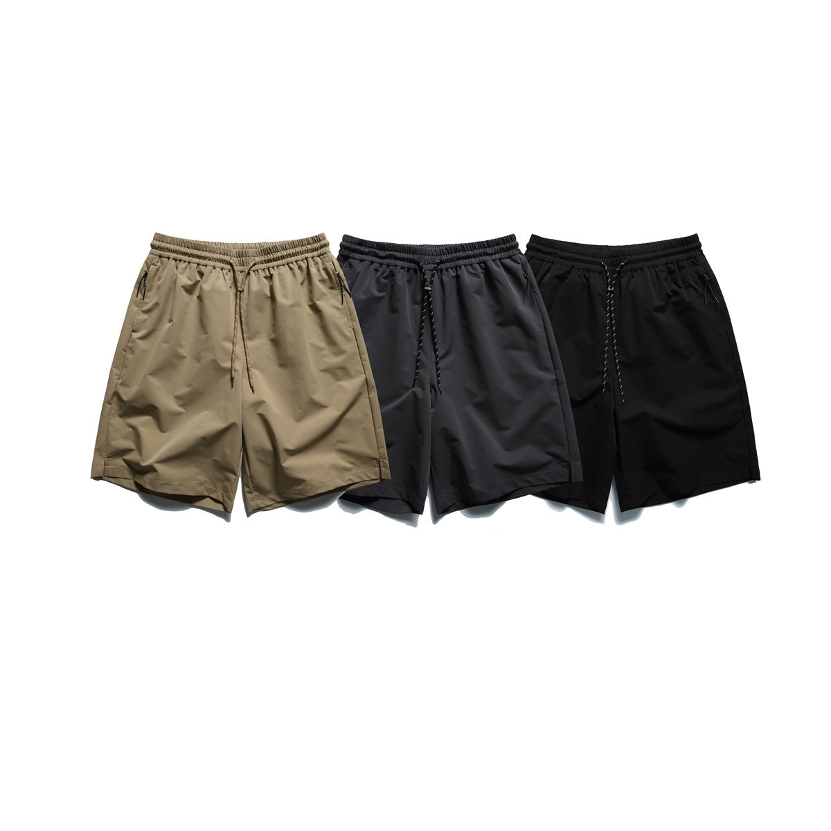 Three pairs of elastic-waist shorts shown from the front in khaki, charcoal gray and black.