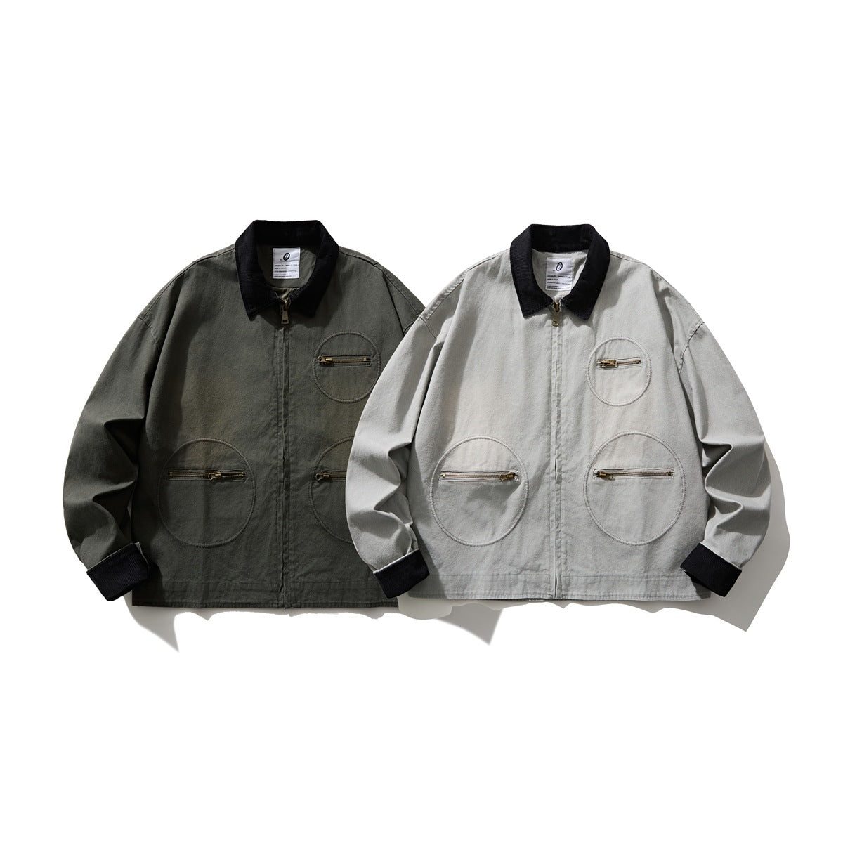 Two jackets shown from the front in dark olive and light gray, each with a black collar and three round zip pockets.