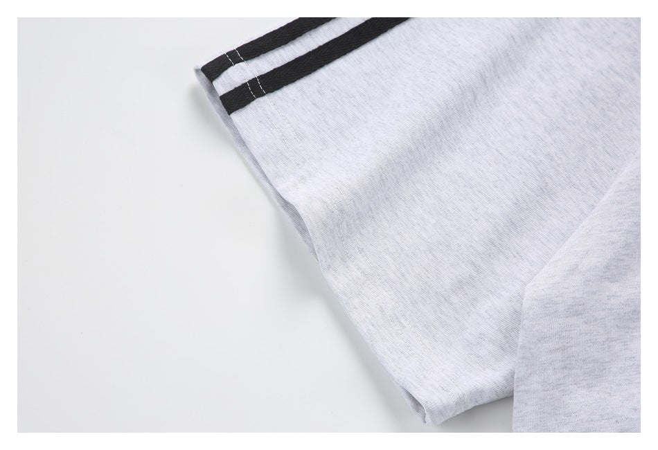 Close-up of a light gray sweatshirt sleeve with black-and-gray striped cuff trim.