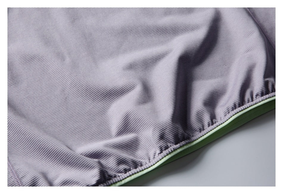 Close-up of the lavender jacket’s gathered hem and pale green trim.