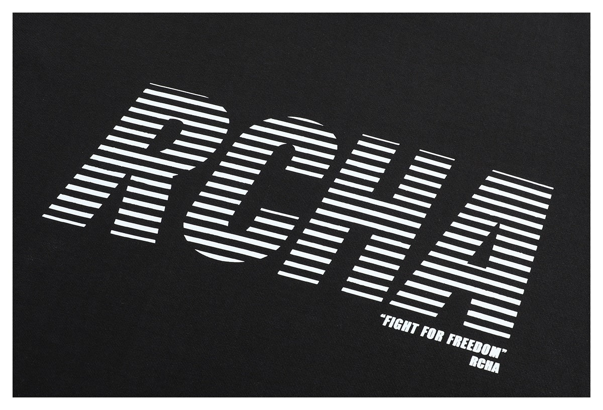 Close-up of the white striped lettering and “FIGHT FOR FREEDOM” print on a black T-shirt.