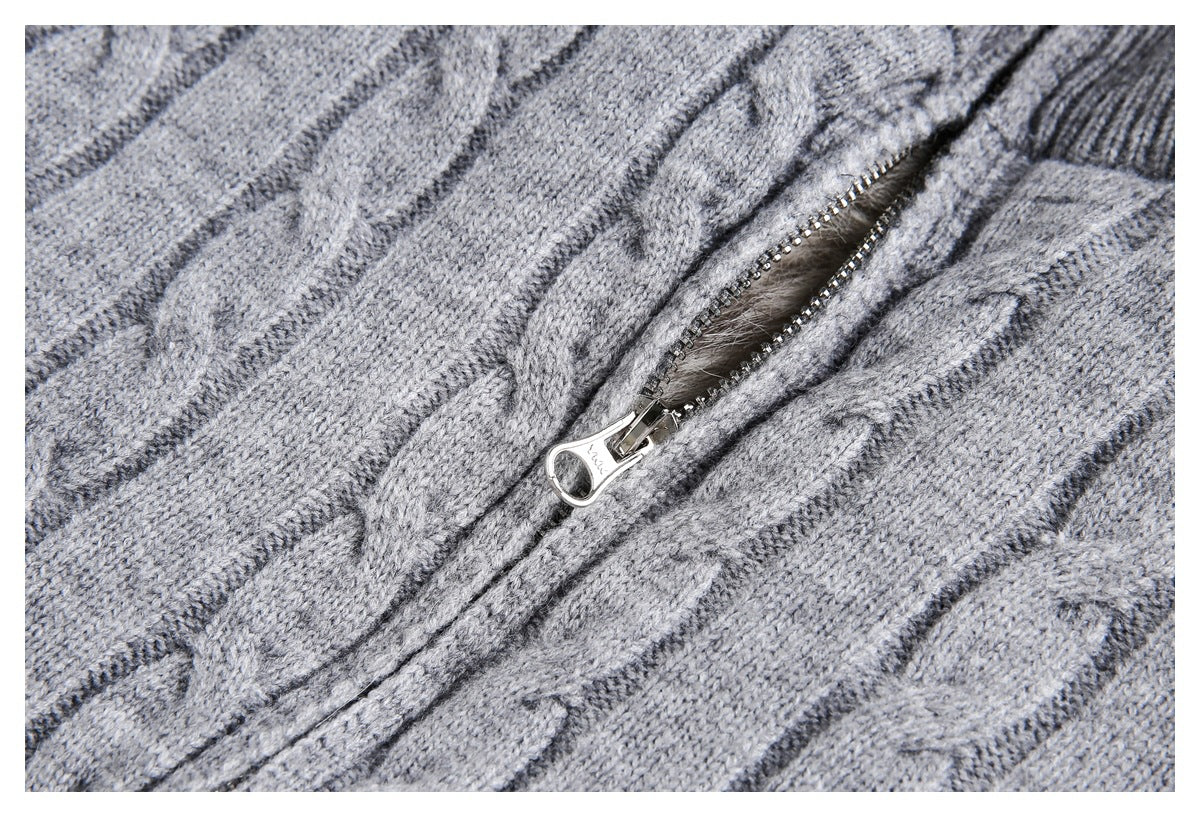 Close-up of the metal zipper and cable-knit texture on a gray sweater.