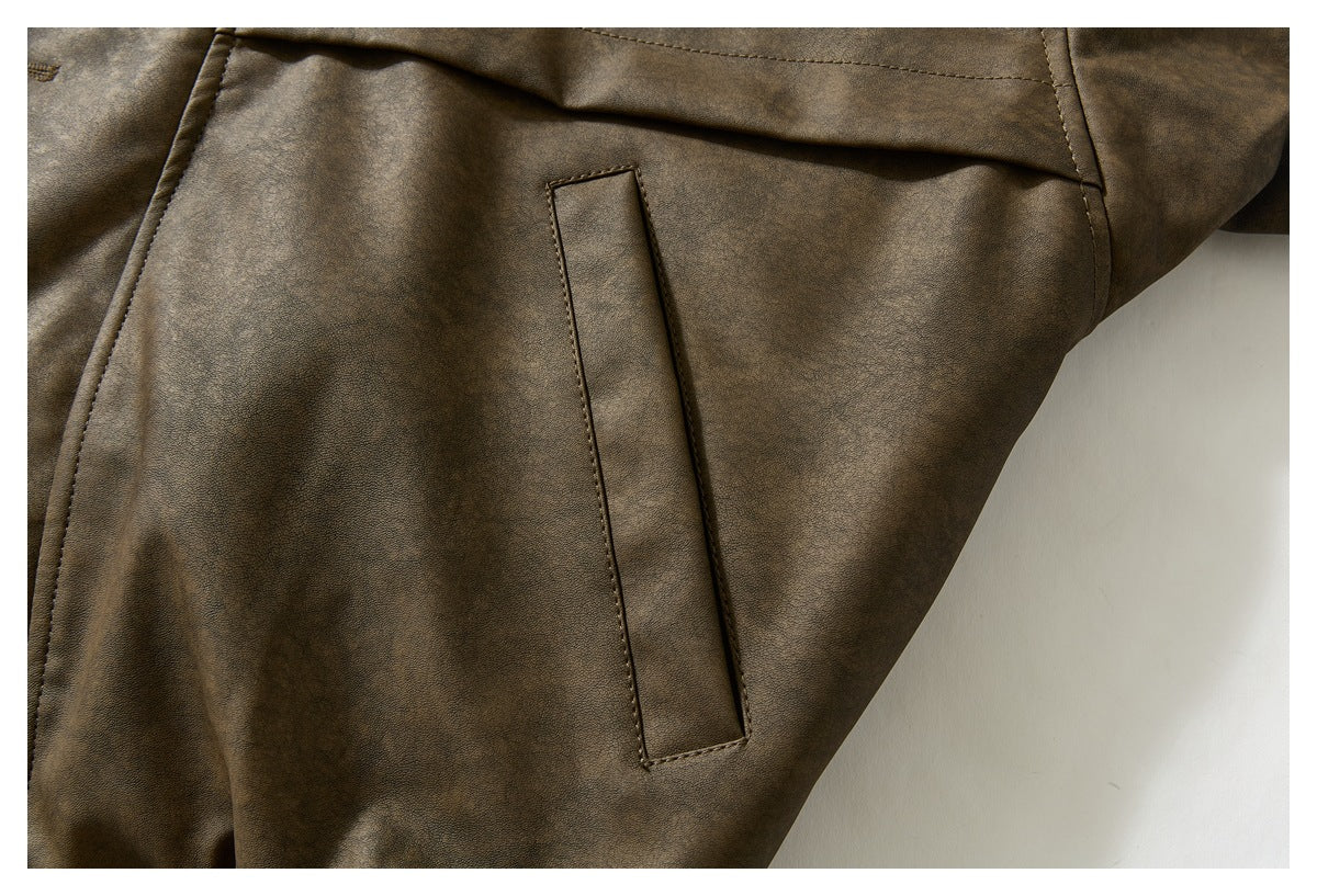 Close-up of a vertical welt pocket on the brown jacket’s front panel.