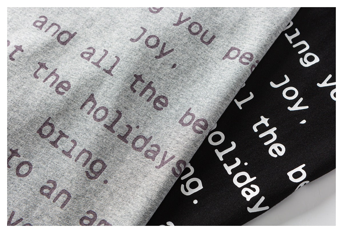 Close-up of heather gray and black shirt fabric printed with repeated English words.