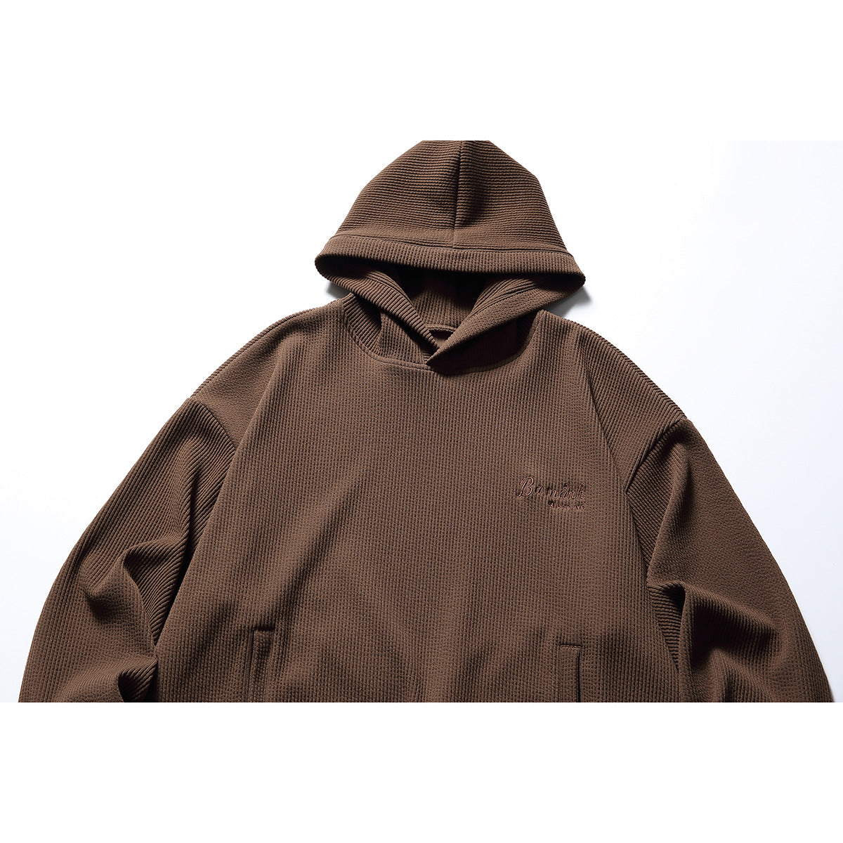 Brown textured pullover hoodie shown from the front, with a hood, kangaroo pocket, and small chest embroidery.