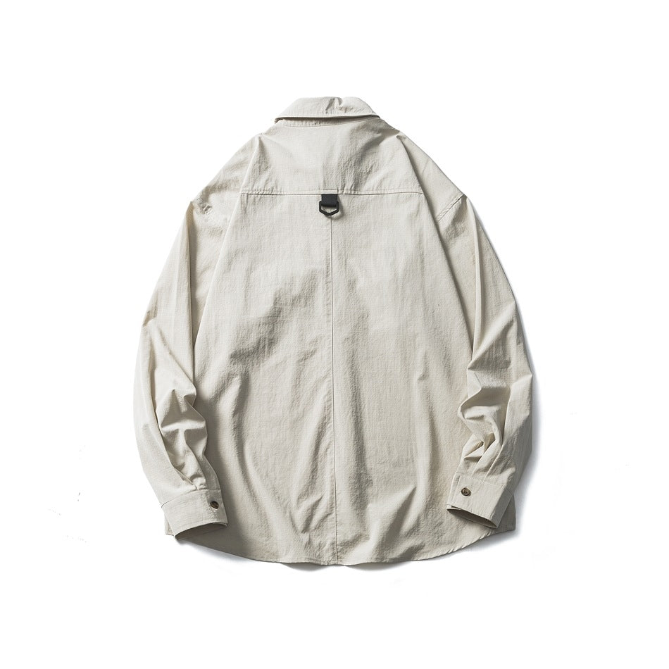 Back view of an off-white long-sleeve button-up shirt laid flat, with a center seam and black loop detail.