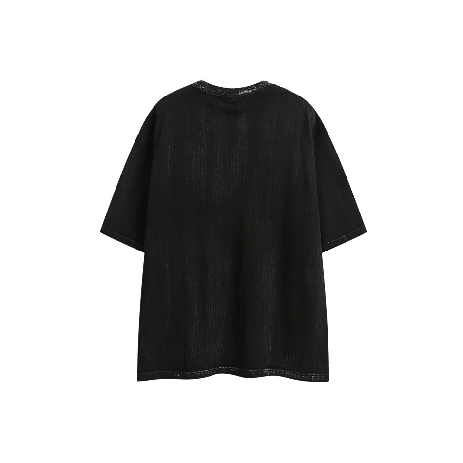 Back view of a black oversized short-sleeve T-shirt laid flat against a white background.