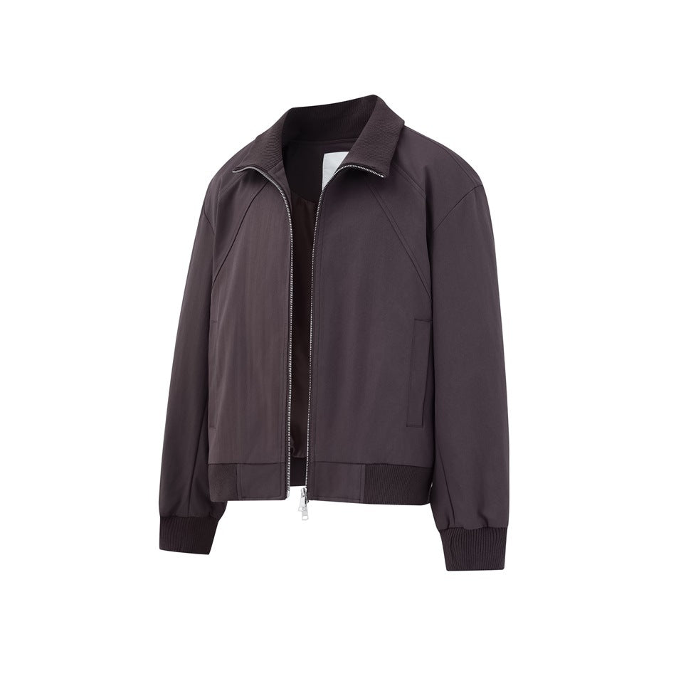 Front view of a dark charcoal zip-front jacket with a ribbed collar, cuffs and hem, plus side pockets.