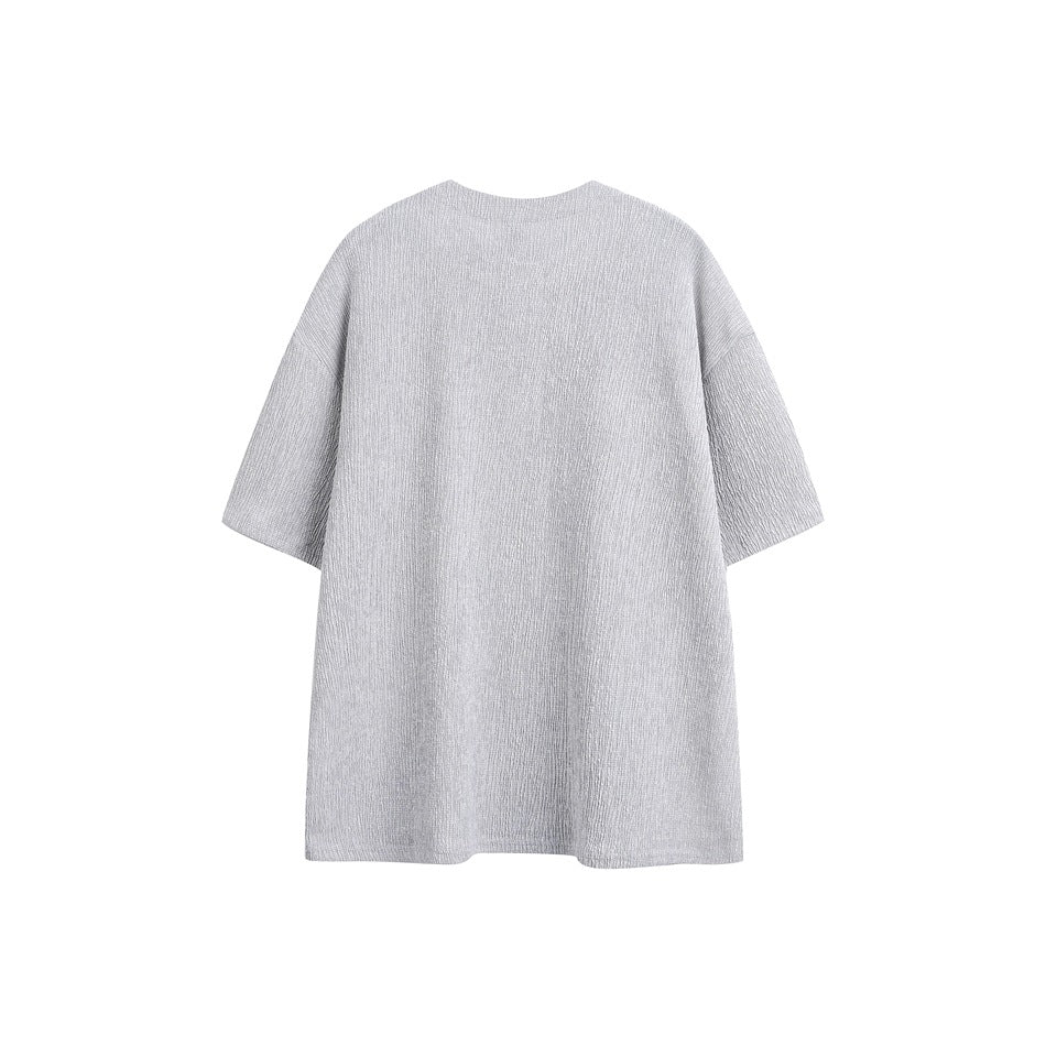 Back view of a light gray oversized short-sleeve top on a plain white background.