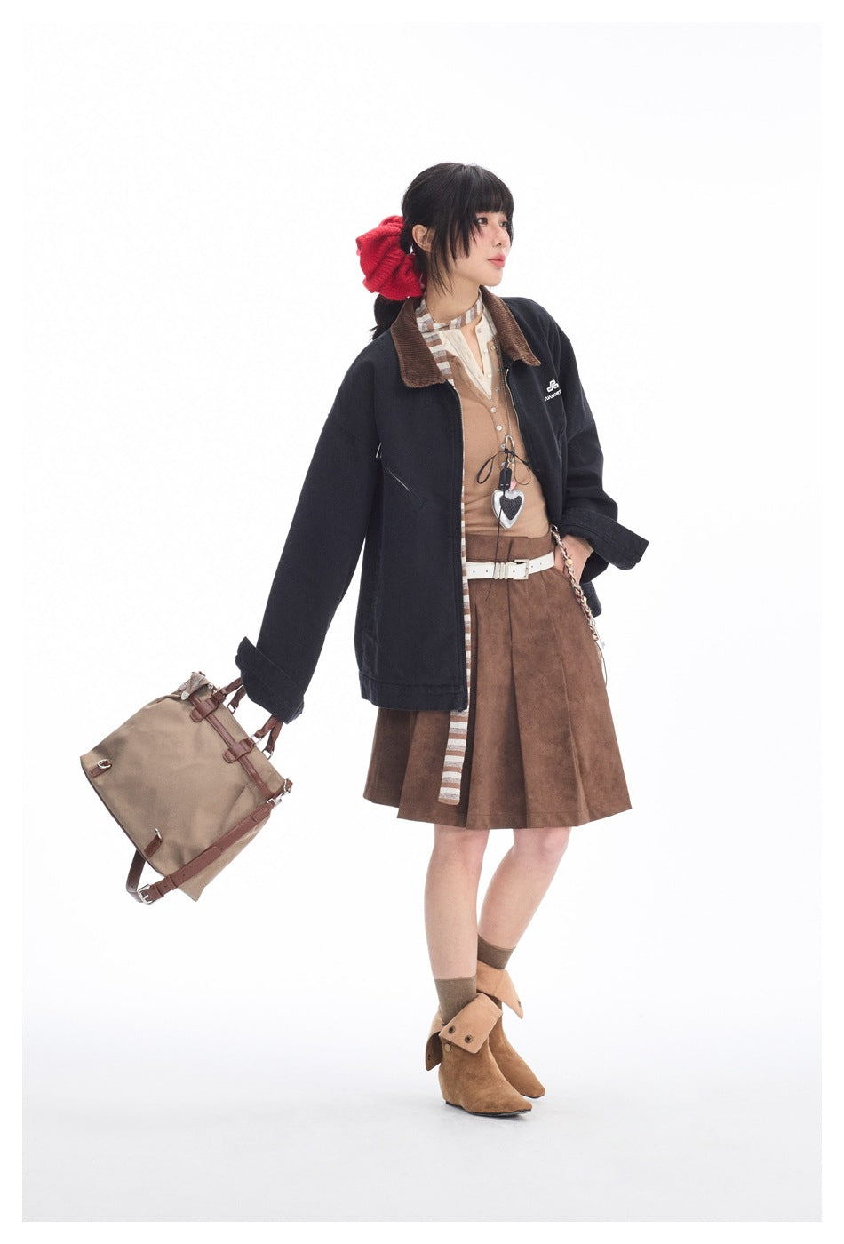 Model wearing a dark navy jacket with a brown collar and a brown flared skirt.