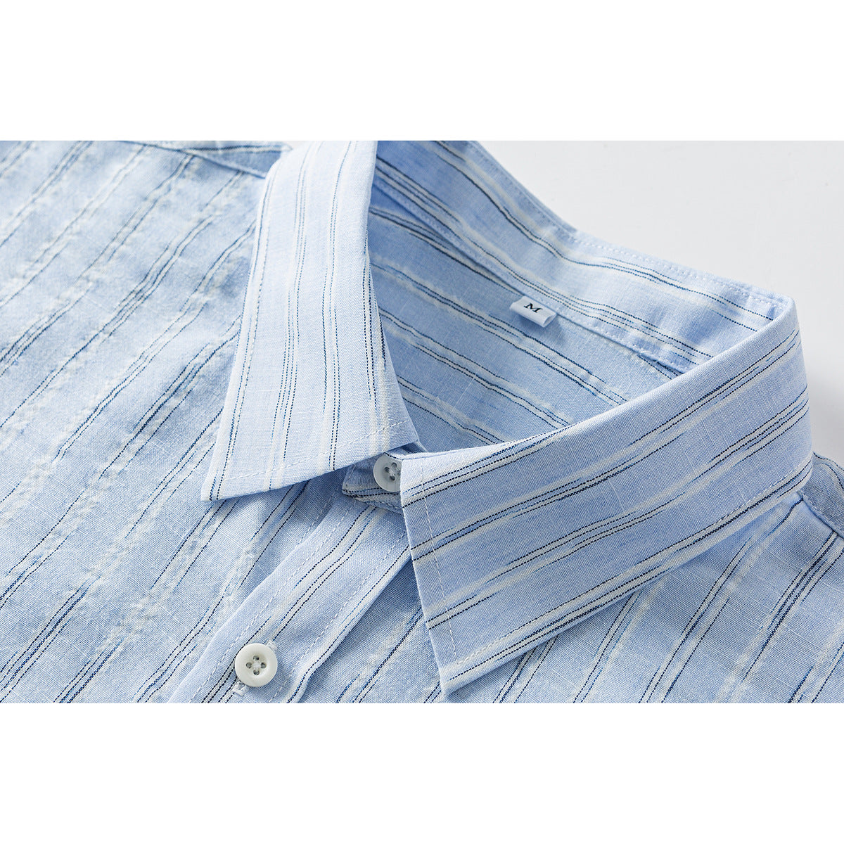 Close-up of a light blue striped shirt collar, placket, white buttons, and inner size label.