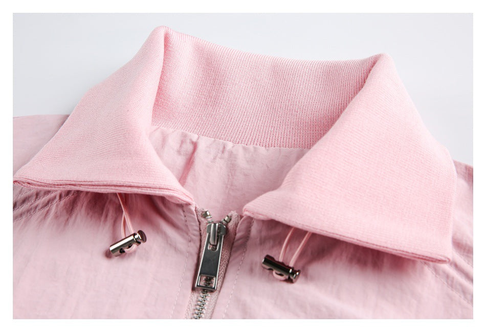 Close-up of the pink jacket's wide ribbed collar, front zipper, and drawcord toggles.