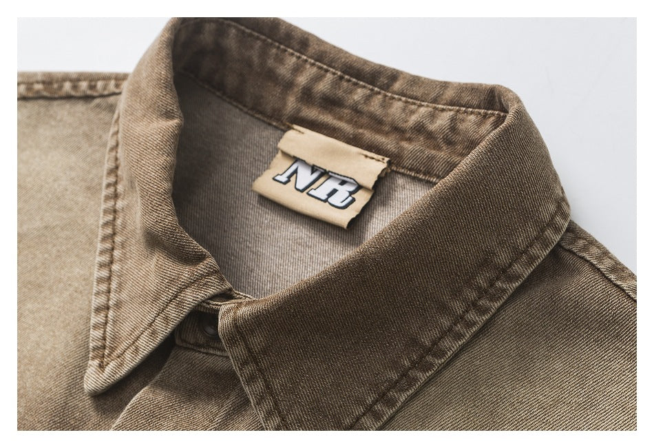 Close-up of a brown washed button-up shirt collar and neck label.