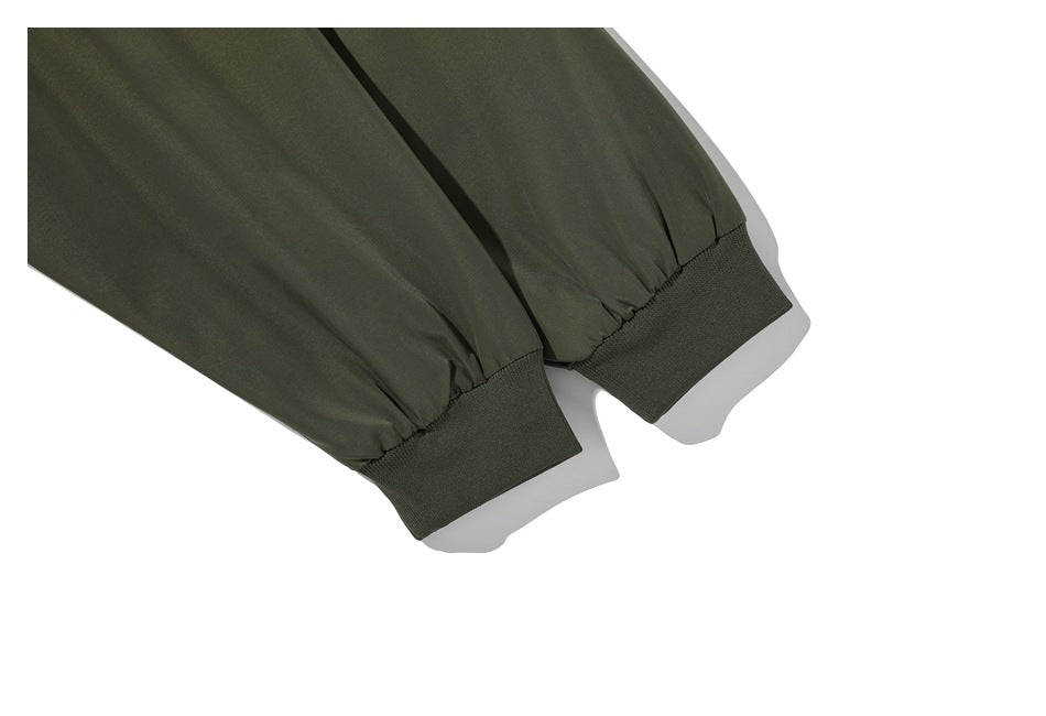 Close-up of olive jacket sleeves gathered into wide ribbed cuffs.