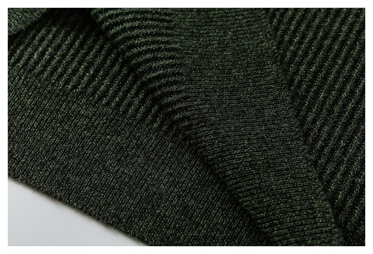 Close-up of deep green rib-knit garment construction, showing a folded seam or edge.