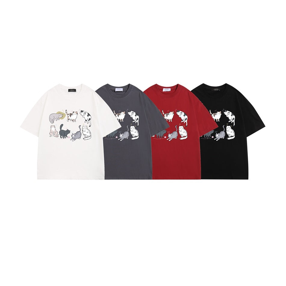 Four short-sleeve crew-neck T-shirts in white, charcoal gray, red, and black, each printed with cats.