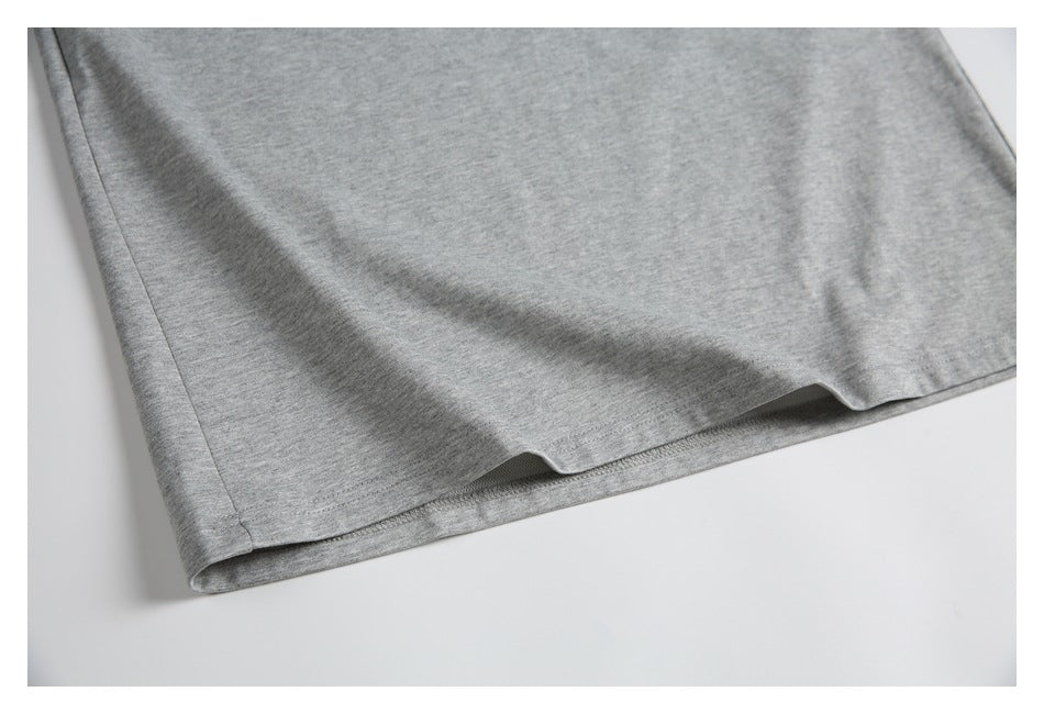 Close-up of the hem and stitching on a gray shirt.