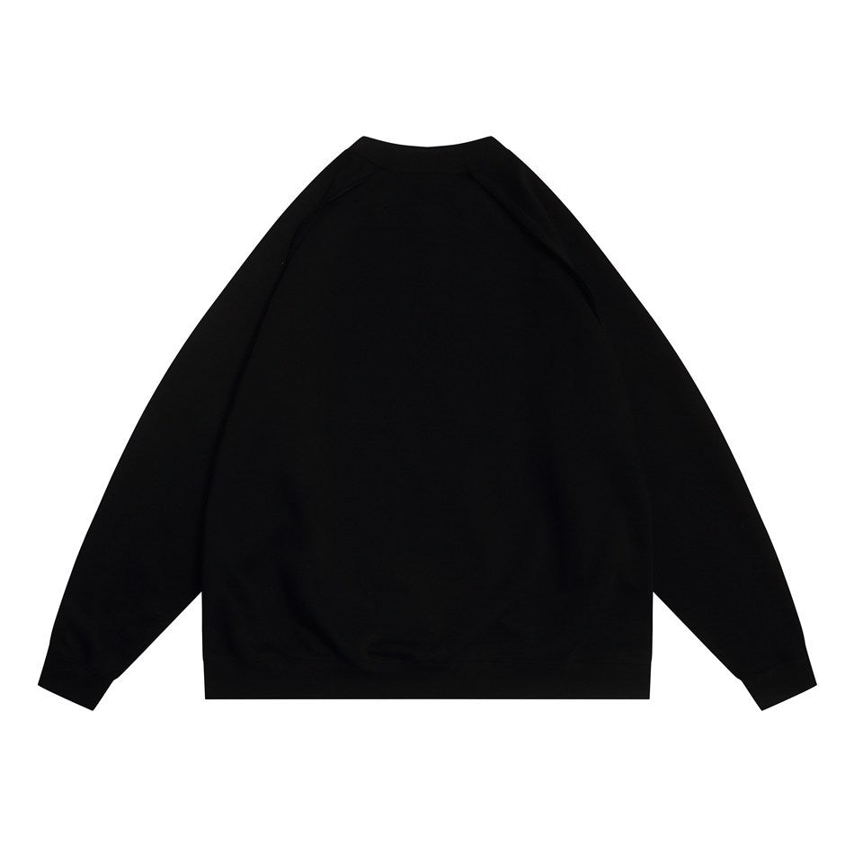 Back view of a plain black raglan crewneck sweatshirt laid flat on a white background.