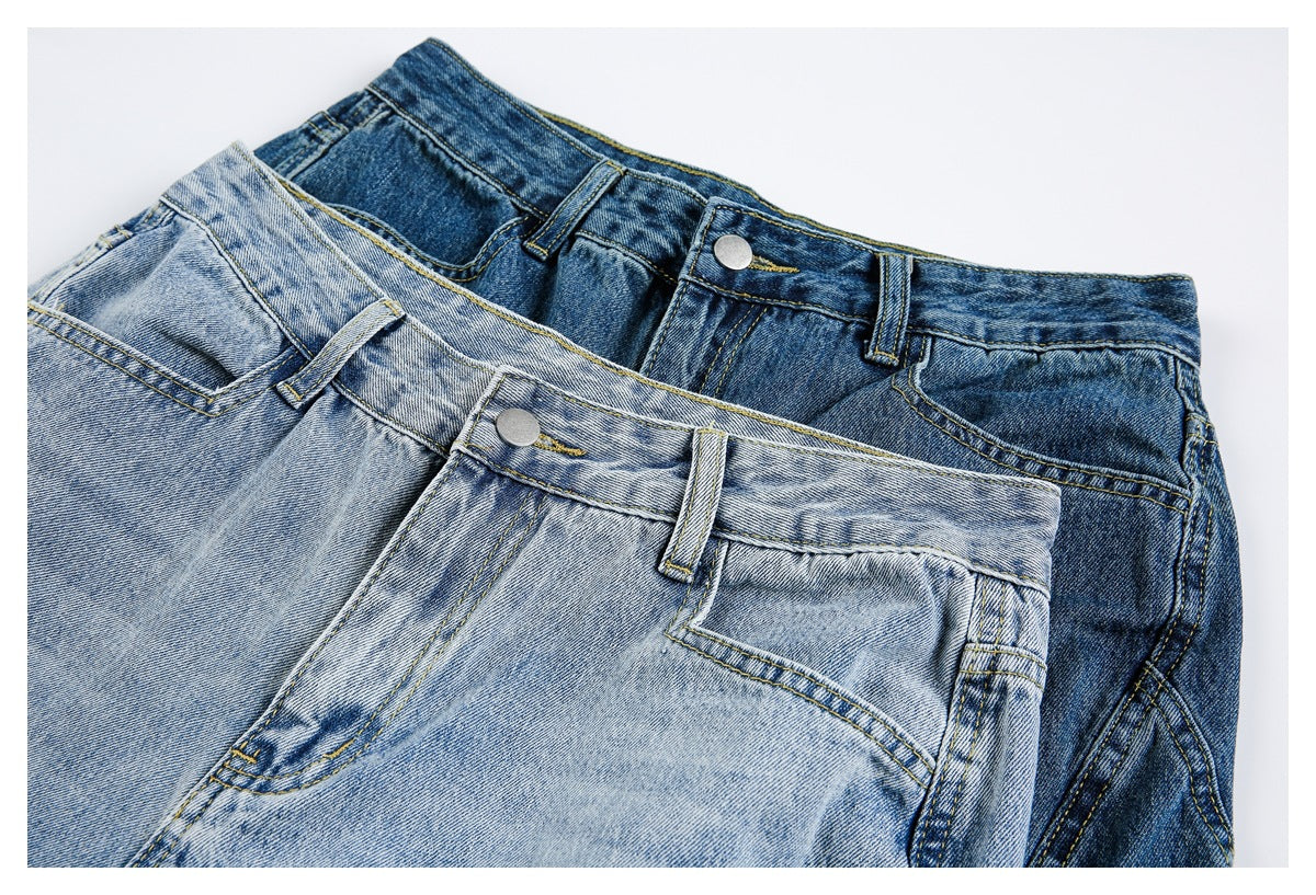 Overlapping light and dark blue jeans show their front waistbands, buttons, belt loops and pockets.
