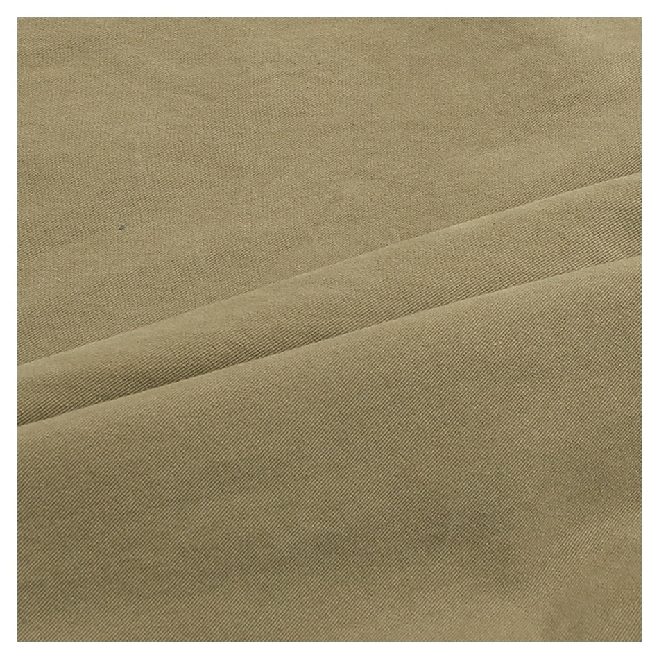 Extreme close-up of khaki fabric showing its diagonal weave and a folded seam.