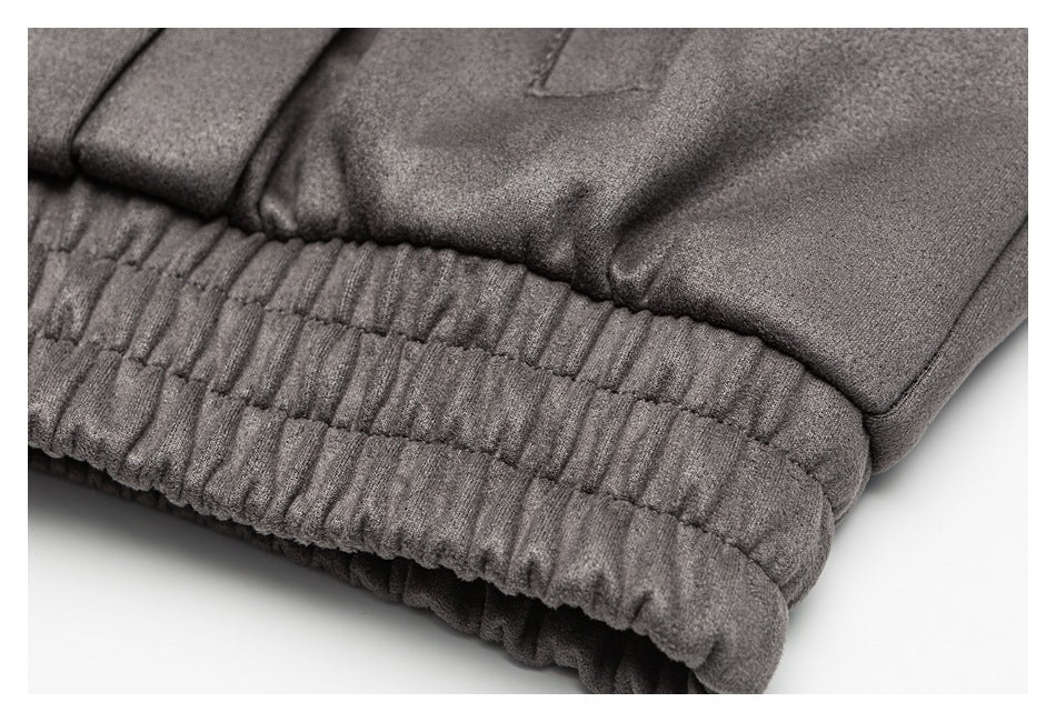 Close-up of a charcoal gray garment's gathered elastic waistband and stitched panels.