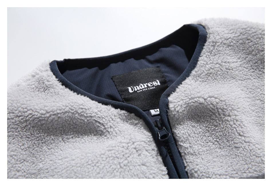 Close-up of the jacket’s rounded collar, navy zipper trim, and interior brand label.
