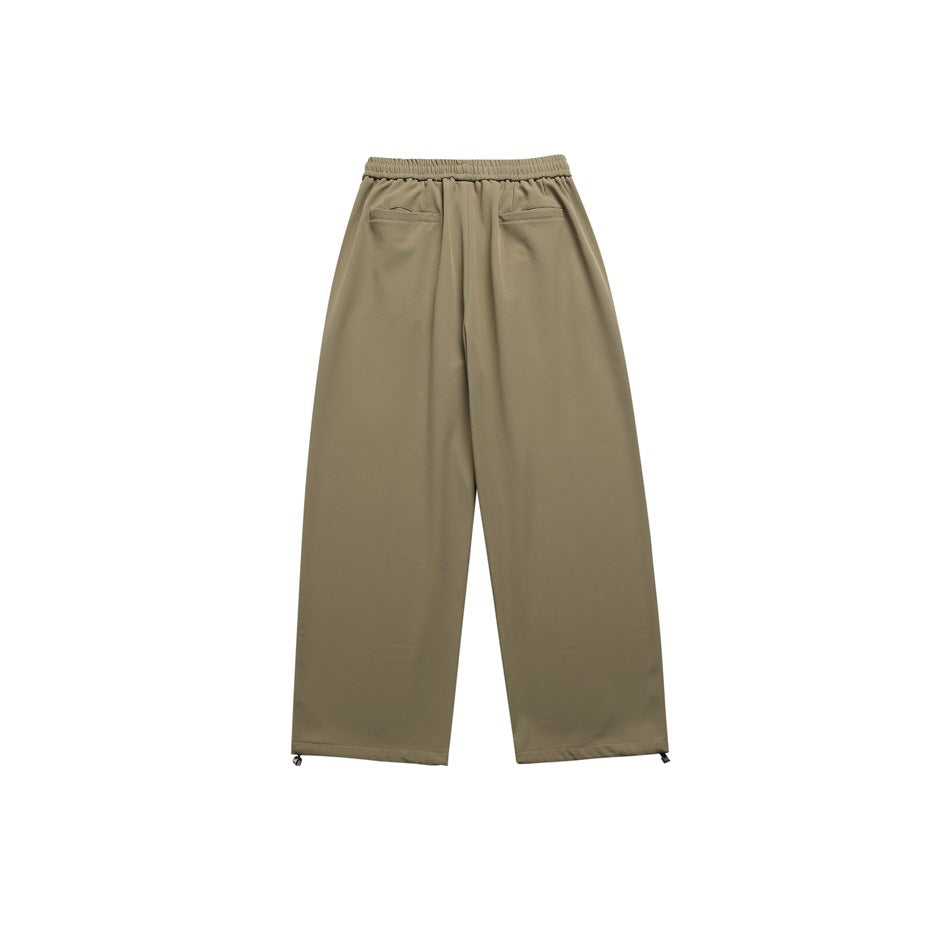 Back view of olive wide-leg trousers with an elastic waist and two rear welt pockets.
