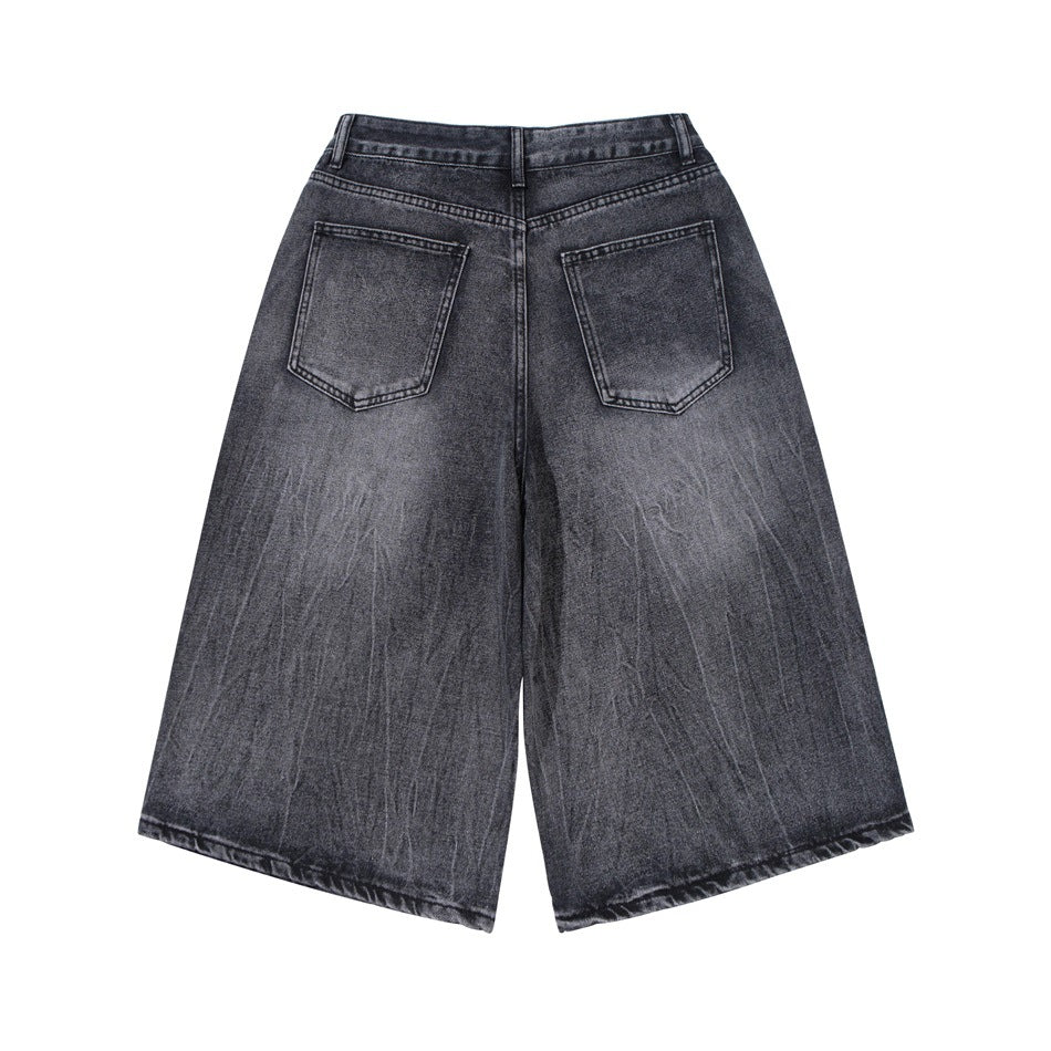 Back view of dark charcoal washed wide-leg denim shorts with two patch pockets.