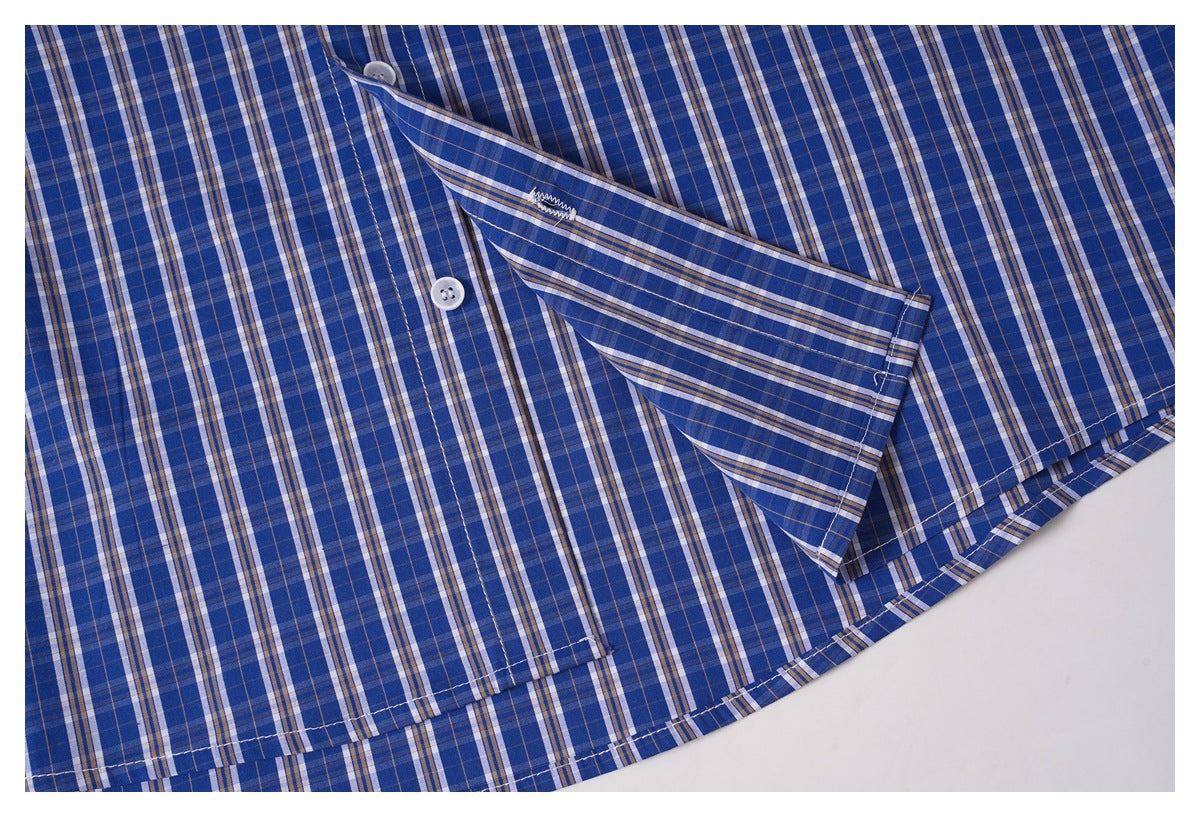Close-up of the blue plaid shirt's curved hem and folded fabric edge.
