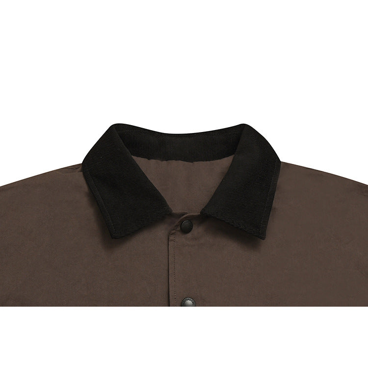 Close-up of a dark brown shirt with a black ribbed collar and black buttons.