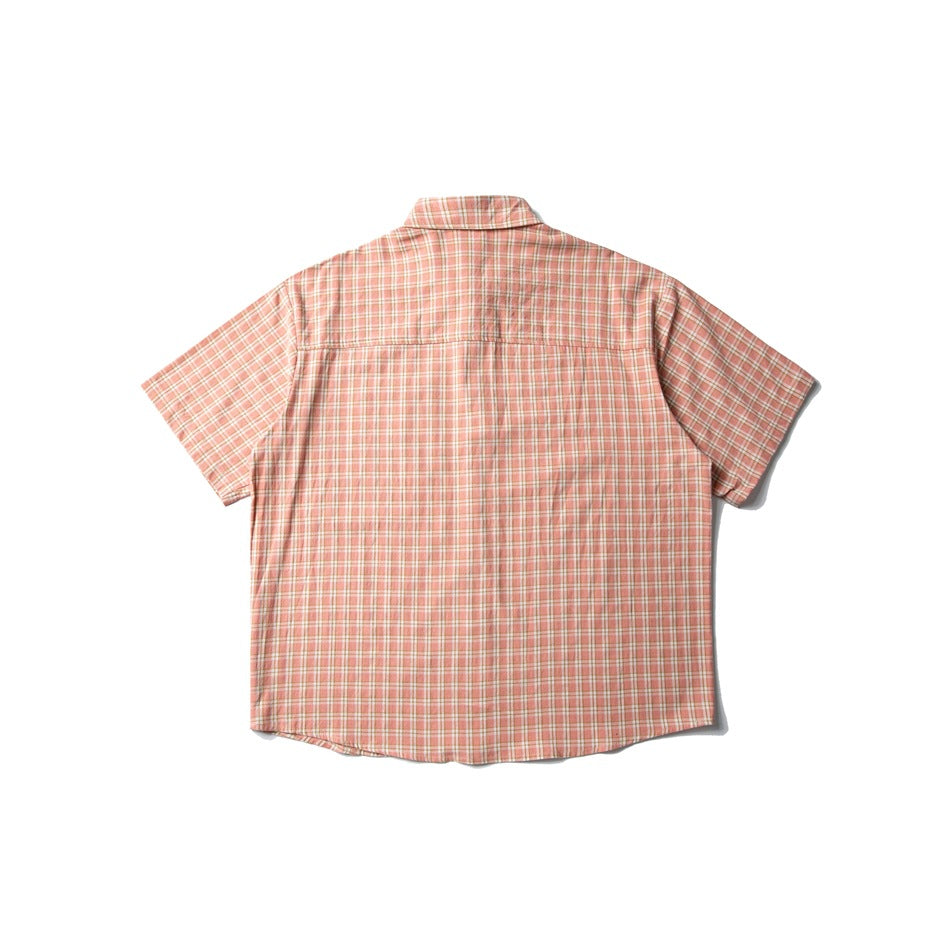 Back view of a peach plaid short-sleeve button-up shirt with a back yoke and straight sleeves.
