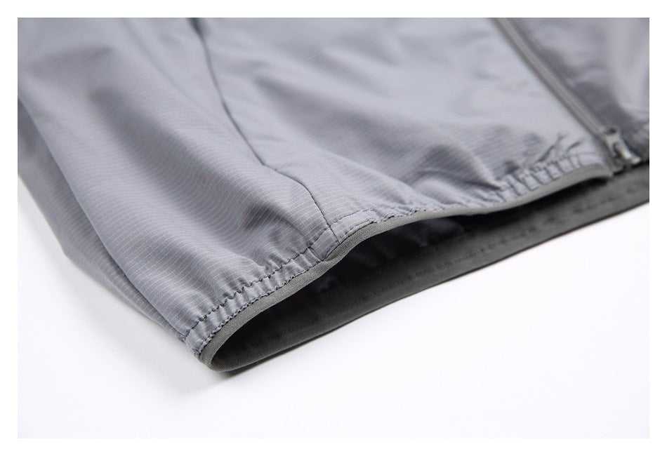 Close-up of the gray garment's gathered edge, dark lining, and zipper.