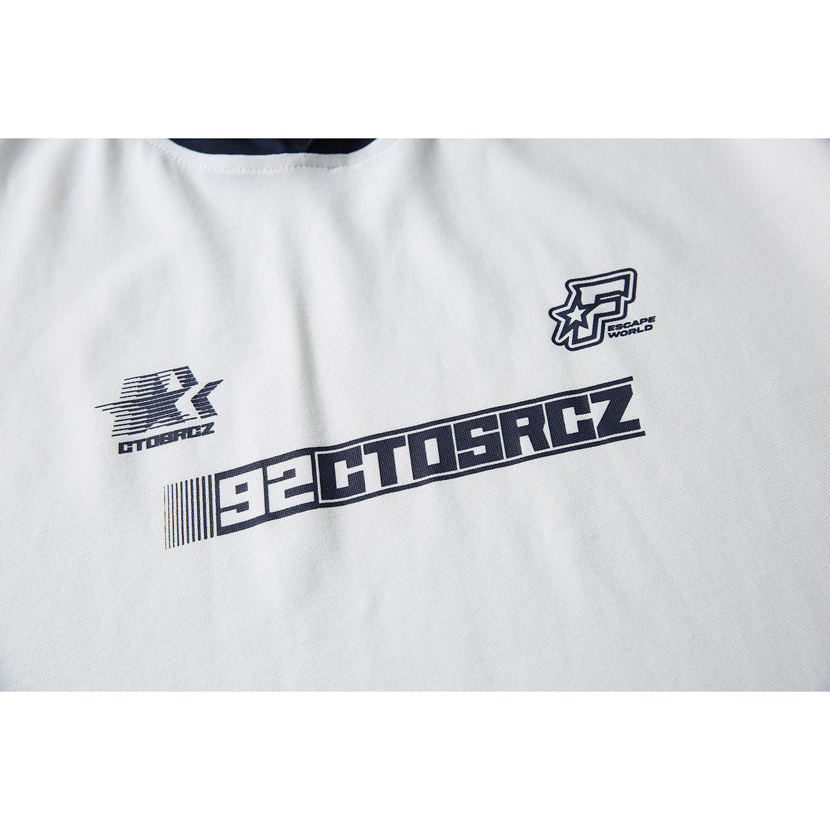 Close-up of dark graphic prints on the chest of a white short-sleeve hoodie.