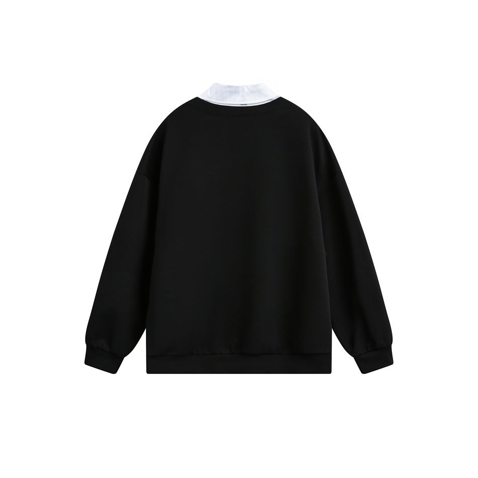 Back of a black pullover with a white collar visible above the neckline.
