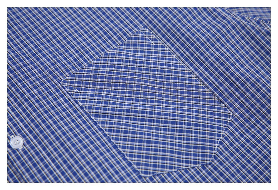 Close-up of a blue-and-white checked shirt chest pocket and surrounding fabric.