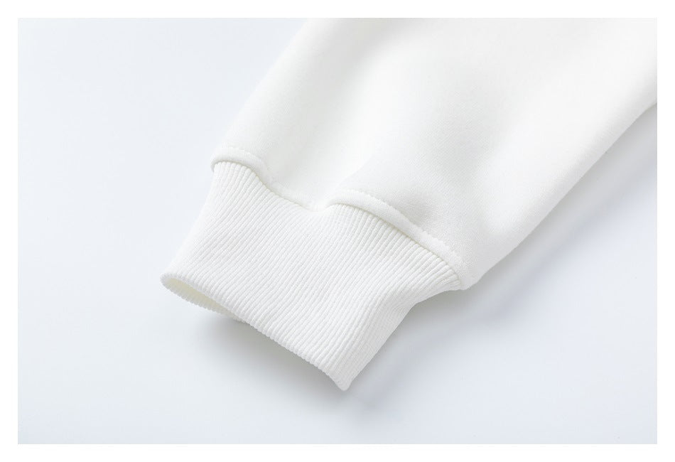 Close-up of a white sweatshirt sleeve ending in a wide ribbed cuff.