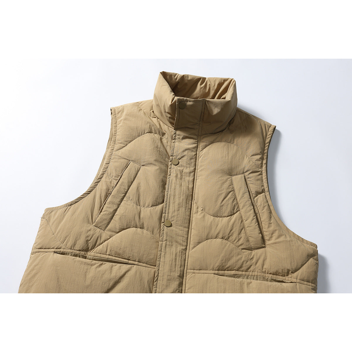 Cropped front view of a tan quilted sleeveless vest with a high collar, snap placket and slanted pockets.