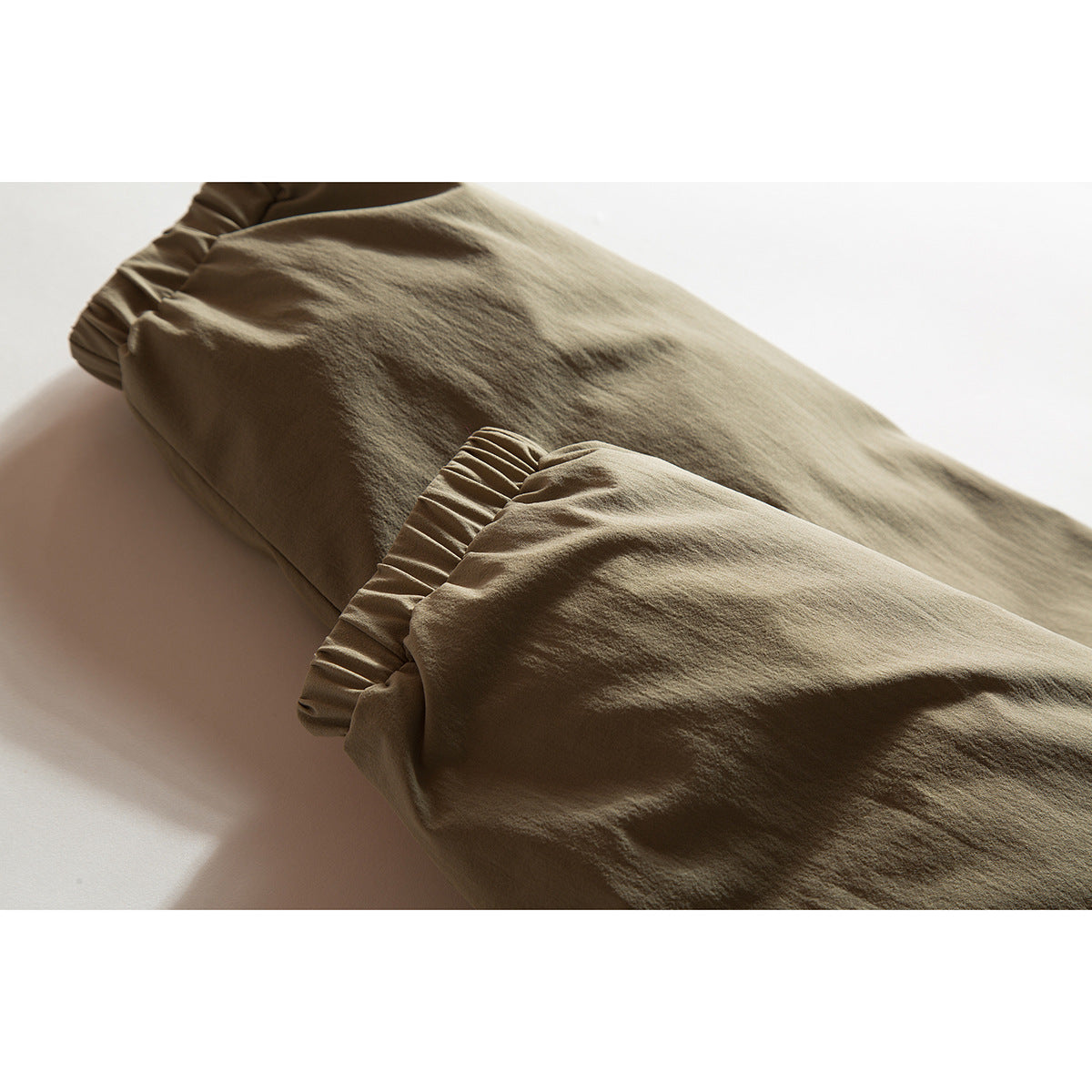 Close-up of a tan jacket sleeve with an elasticated cuff.