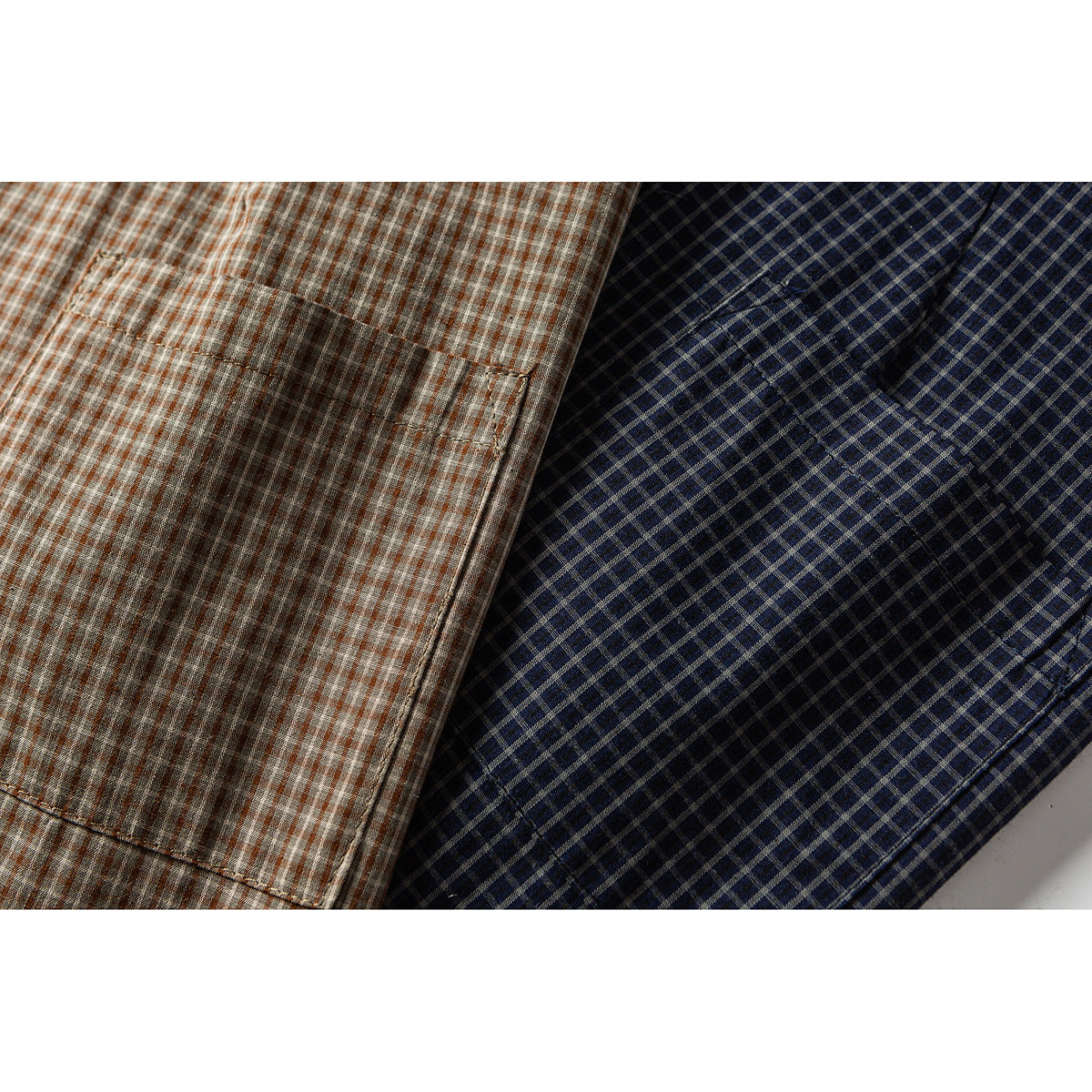 Close-up of chest pockets on brown and navy plaid shirts.