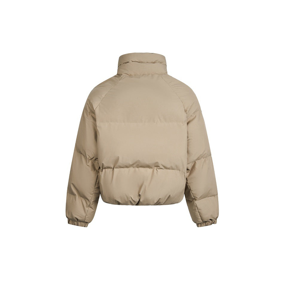 Back view of a beige cropped puffer jacket with a high collar, raglan sleeves, and elastic cuffs.