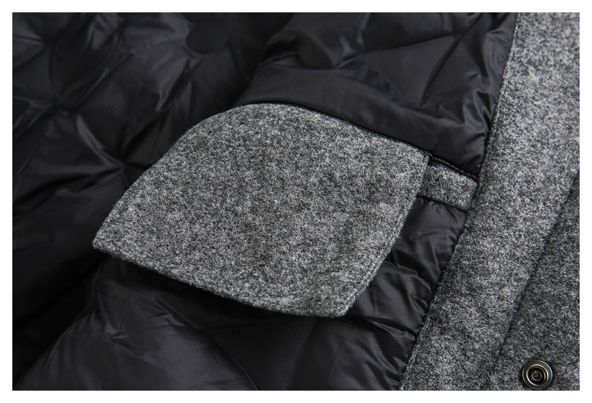 Close-up of a gray coat pocket flap against black quilted lining, with a snap button visible.