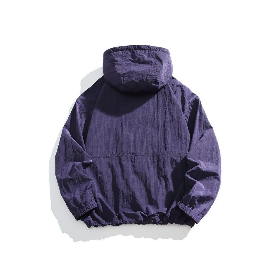 Back view of a deep purple hooded jacket with elastic cuffs and hem, displayed against a white background.