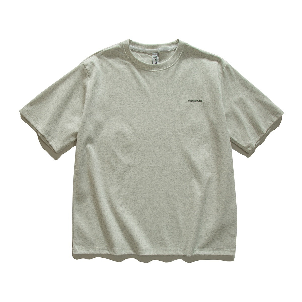Light heathered gray crewneck T-shirt front with a small left-chest text print, flat lay